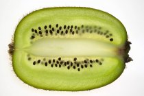 Kiwi fruit, lengthwise slice — Stock Photo