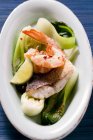 Shrimps and fish with pak choi — Stock Photo