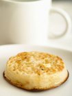 Closeup view of toasted crumpet with butter on white dish — Stock Photo