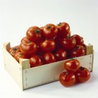 Tomatoes in wooden box — Stock Photo