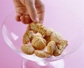 Hand taking Italian biscotti — Stock Photo