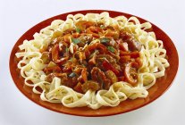 Meat ragout on ribbon pasta — Stock Photo