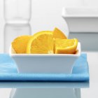 Orange quarters in small bowl — стоковое фото