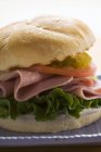 Ham and gherkin in kaiser roll — Stock Photo