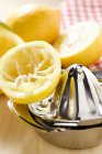 Lemons with citrus squeezer — Stock Photo