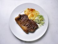 Loin steak with fried potatoes — Stock Photo