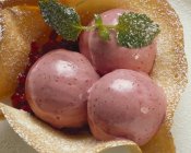 Three scoops of cranberry sorbet — Stock Photo