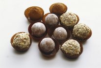 Closeup view of assorted truffles on white surface — Stock Photo