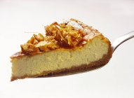 Piece of cheesecake with almonds — Stock Photo