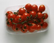 Cherry tomatoes in plastic punnet — Stock Photo