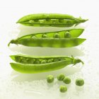 Fresh green pods with peas — Stock Photo