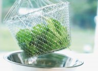Spinach leaves in colander — Stock Photo