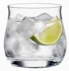 Glass of water with lime slice — Stock Photo