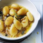Potato balls in sage butter — Stock Photo