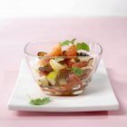 Closeup view of exotic fruit salad in glass bowl — Stock Photo