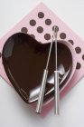 Closeup top view of heart-shaped bowls with fondue forks — Stock Photo