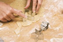 Cropped view of cutting out star-shaped biscuit dough — Stock Photo