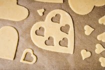 Cut-out heart-shaped biscuits — Stock Photo