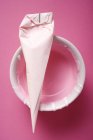 Closeup top view of piping bag with pink icing — Stock Photo