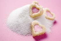 Heart-shaped biscuits on granulated sugar — Stock Photo