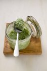Closeup view of corn salad pesto in glass jar and on spoon — Stock Photo