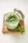 Closeup view of corn salad pesto in glass jar — Stock Photo