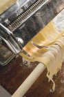 Tagliatelle coming out of maker — Stock Photo