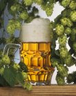 Крупный план пива Хеллес в танкарде с хмелем — стоковое фото