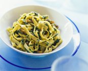 Tagliatelle pasta with ceps and basil — Stock Photo