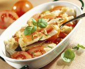Baked Cod and tomato with basil — Stock Photo