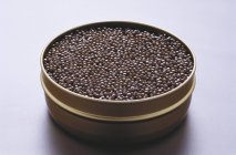Black caviar in tin — Stock Photo