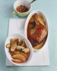 Duck leg with sultanas and onions — Stock Photo