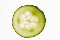 Slice of cucumber with backlit — Stock Photo