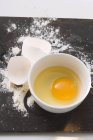 Casca de ovo e farinha na mesa — Fotografia de Stock