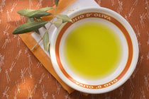 Olivenöl in Schüssel auf Serviette — Stockfoto