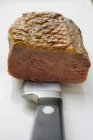 Fried duck breast on knife — Stock Photo