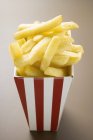 Chips in striped box — Stock Photo