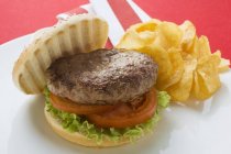 Hamburger with fried potato crisps — Stock Photo