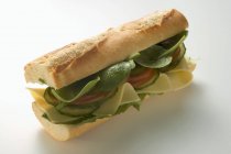 Baguette with cheese and salad — Stock Photo