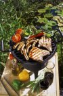 Sausages and vegetables on barbecue — Stock Photo