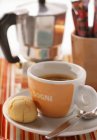 Closeup view of Espresso and pastry near coffee machine — Stock Photo