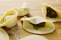 Filling pasta parcels with beef — Stock Photo