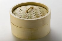 Closeup view of one bamboo steamer on white surface — Stock Photo