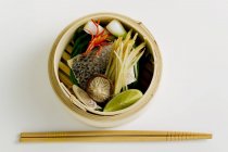 Морской окунь с имбирем и овощами на белом фоне — стоковое фото