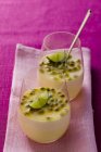 Passionfruit cream with coconut and lime in glasses — Stock Photo