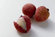 Three fresh lychees — Stock Photo