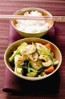 Swordfish with vegetables near bowl of rice — Stock Photo