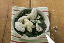 Closeup view of Ricotta and Mortadella Gnocchi with spinach and Parmesan — Stock Photo