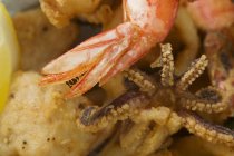 Closeup view of deep-fried scallops, octopus and shrimp tail — Stock Photo