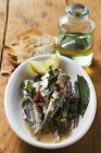 Fried anchovies with dried tomatoes — Stock Photo